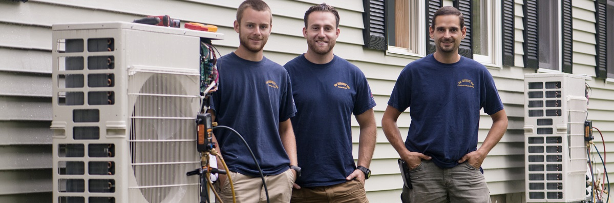 Heat pump installers outside home with heat pumps