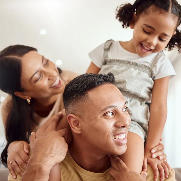 A young family, all smiles. 