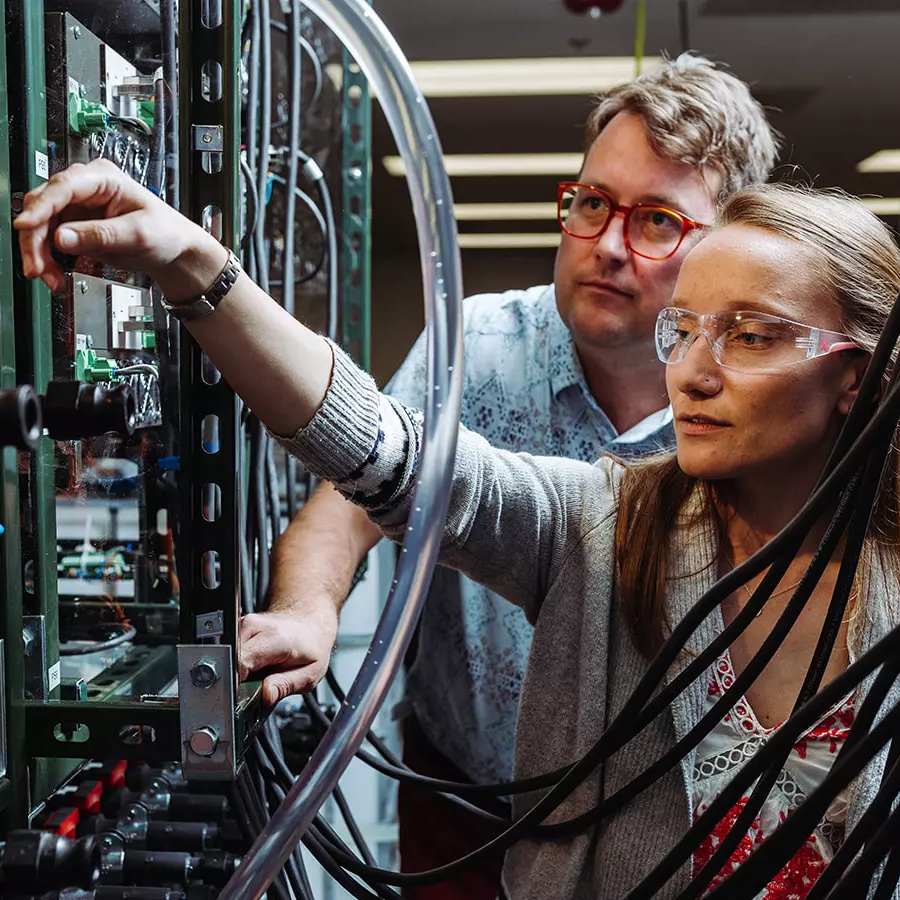 Two scientists working with equipment