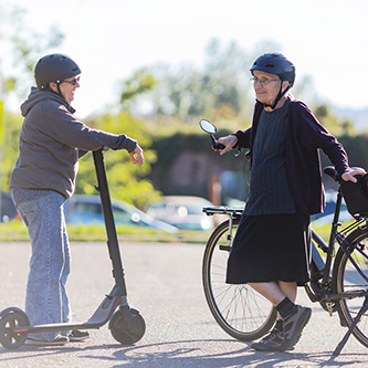 Women with electric vehicles talking