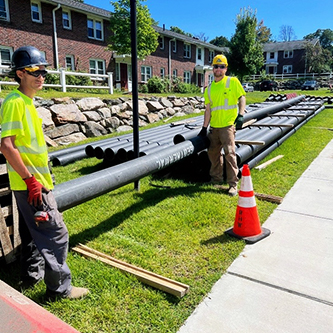 Thermal network piping staged for installation along a residential street.