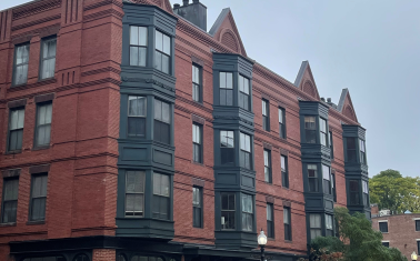Older 4-story brick mixed-use building 