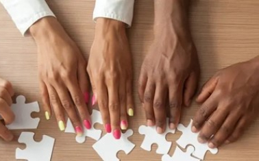 Photo of hands putting together a puzzlee