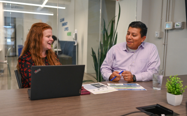 Two people in office having lively discussion