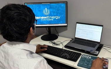 Teja Sunkari working at a desk in the Renew Energy Partners office, focused on a task during his internship.