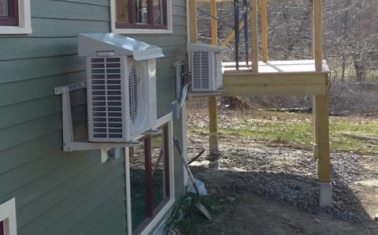 The image above shows a heat pump installed with a drip cap, which is a good way to protect the outdoor unit if it needs to be installed under a roof drip line. (Image from Steven Winters Associates, Inc.)