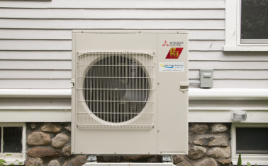 Residential air-source heat pump installed outside a home.