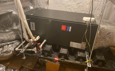 This ducted unit located in Asa Hopkins’s attic heats, cools, and dehumidifies his home’s upstairs bedrooms and bathrooms while ductless units serve the downstairs space. (Photo provided by Asa Hopkins)