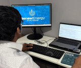 Teja Sunkari working at a desk in the Renew Energy Partners office, focused on a task during his internship.