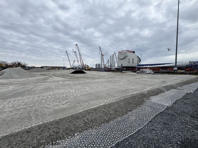 Land prepped for construction with levelled soil over a metal mesh