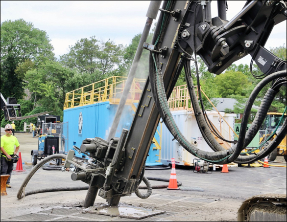 Drilling equipment installing geothermal boreholes for a district thermal energy system.