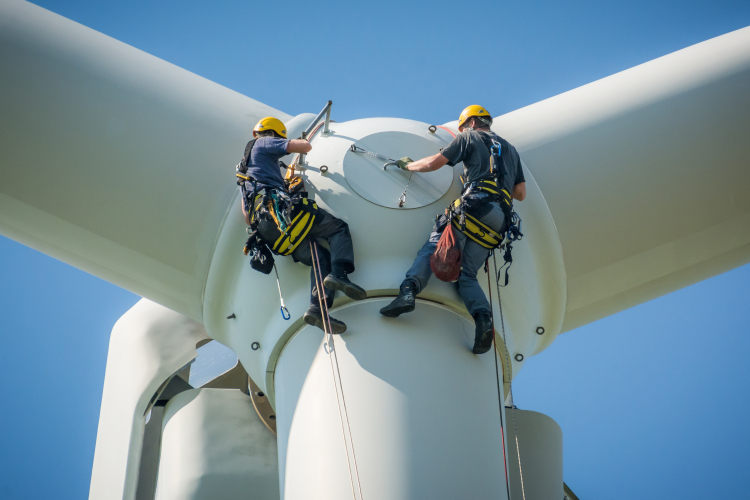 Need for Speed blog hero Two men, suspended from top of wind turbine performance maintenance.