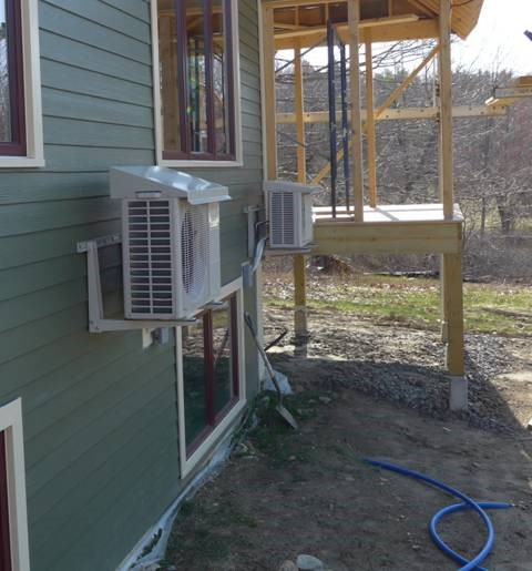 The image above shows a heat pump installed with a drip cap, which is a good way to protect the outdoor unit if it needs to be installed under a roof drip line. (Image from Steven Winters Associates, Inc.)
