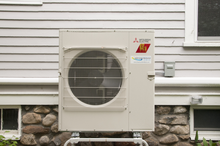 Residential air-source heat pump installed outside a home.