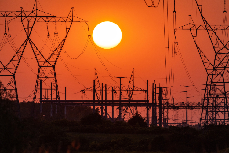 Sun over power lines.