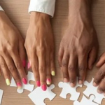 Photo of hands putting together a puzzlee