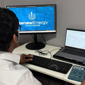Teja Sunkari working at a desk in the Renew Energy Partners office, focused on a task during his internship.