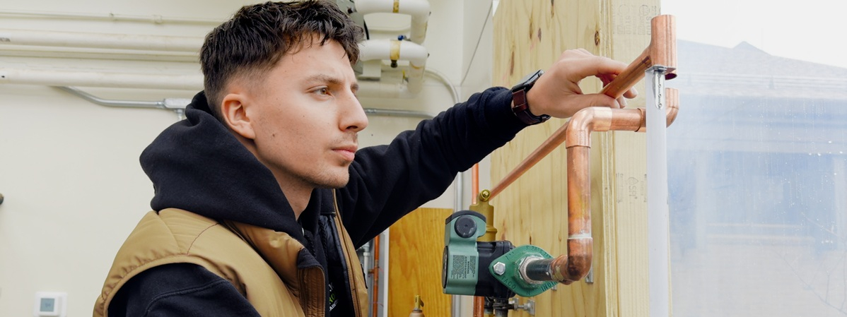 Young person working on HVAC installation