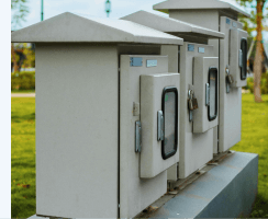 Outdoor electrical utility cabinets installed near a building for power distribution.
