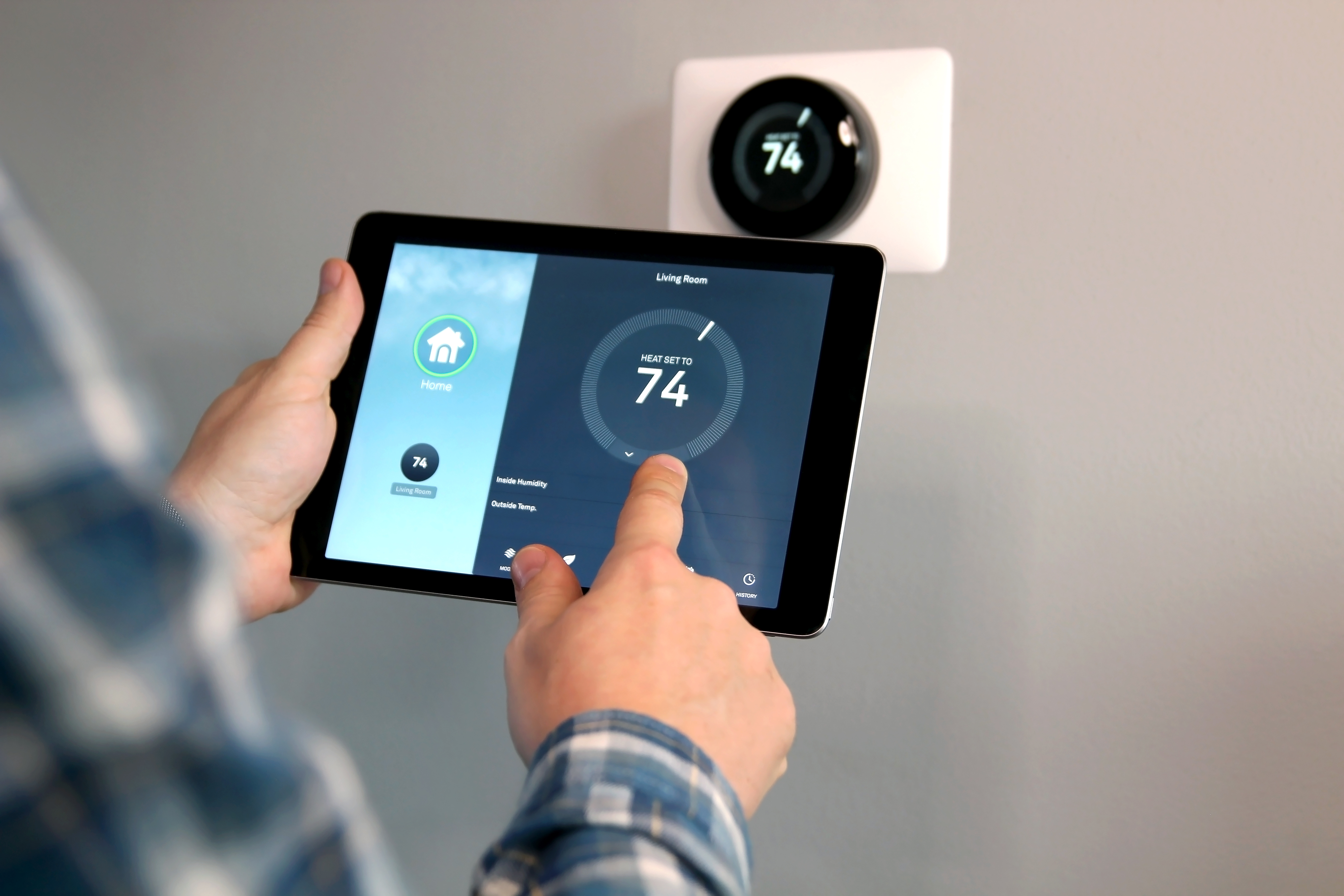 Smart thermostat being operated on tablet.