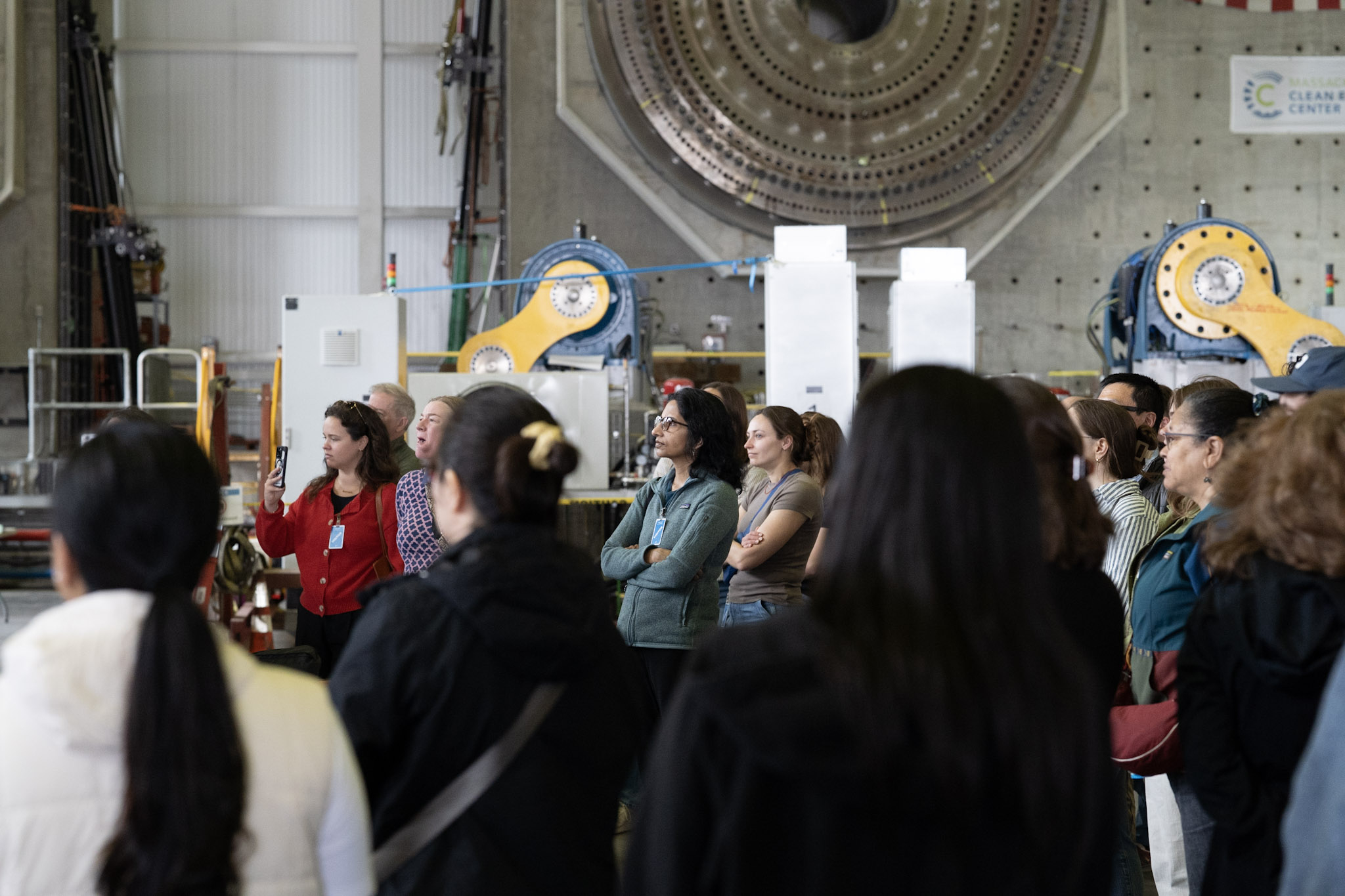 A group of people listening to a speaker.