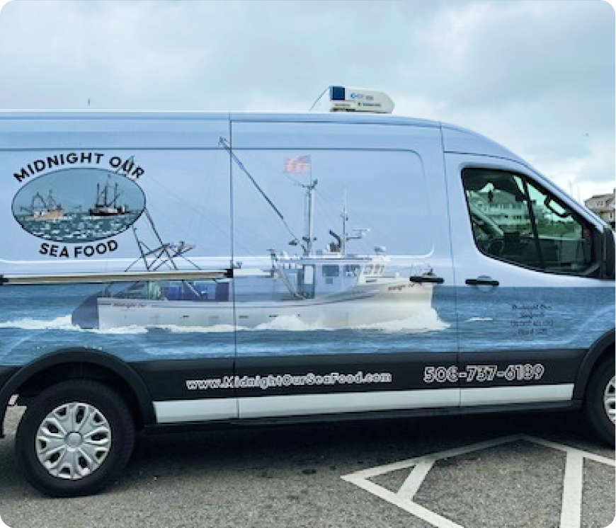 Commercial seafood delivery van wrapped with fishing boat graphics and seafood company branding.