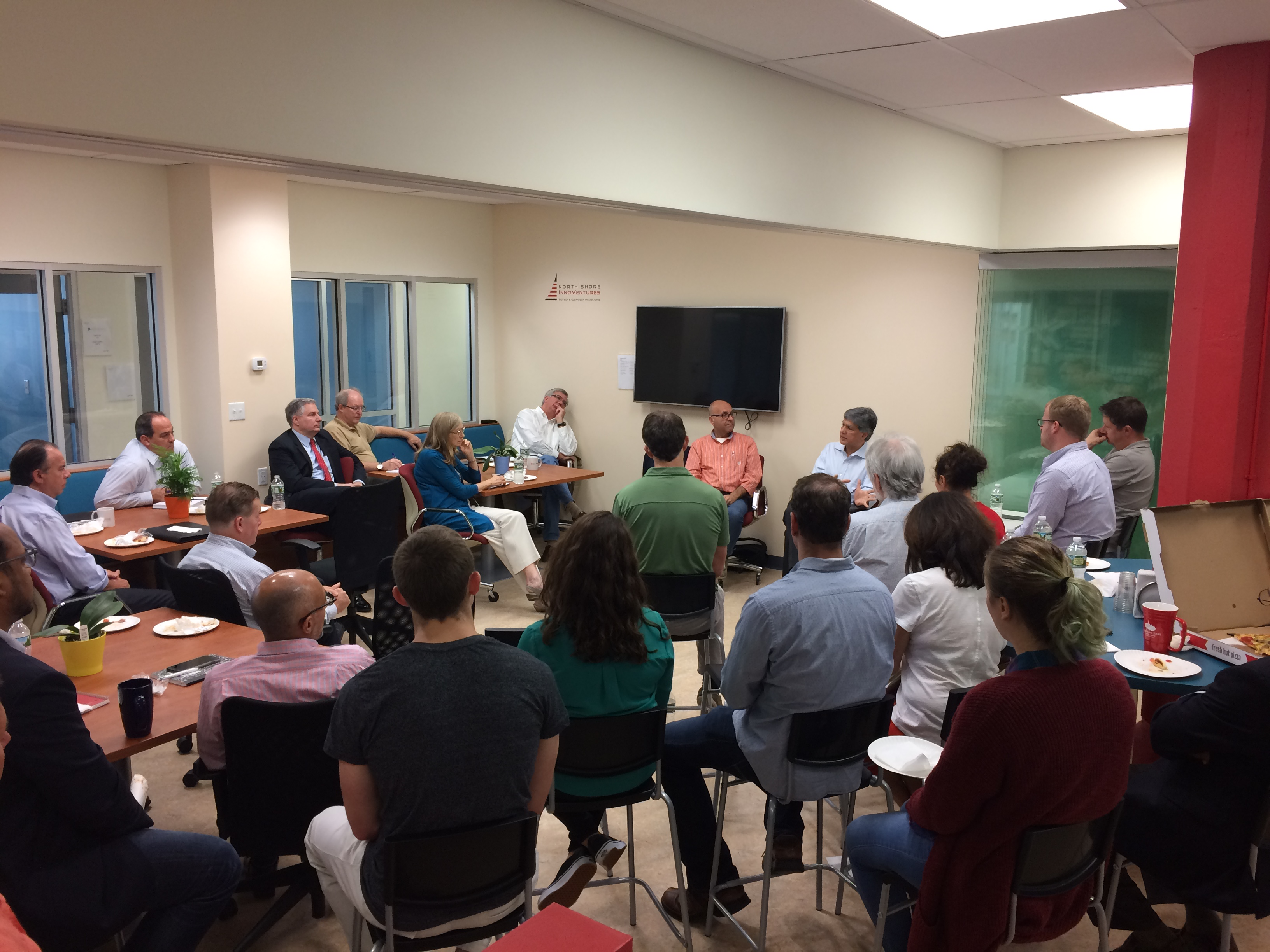 A group of people sitting around a conference room table.