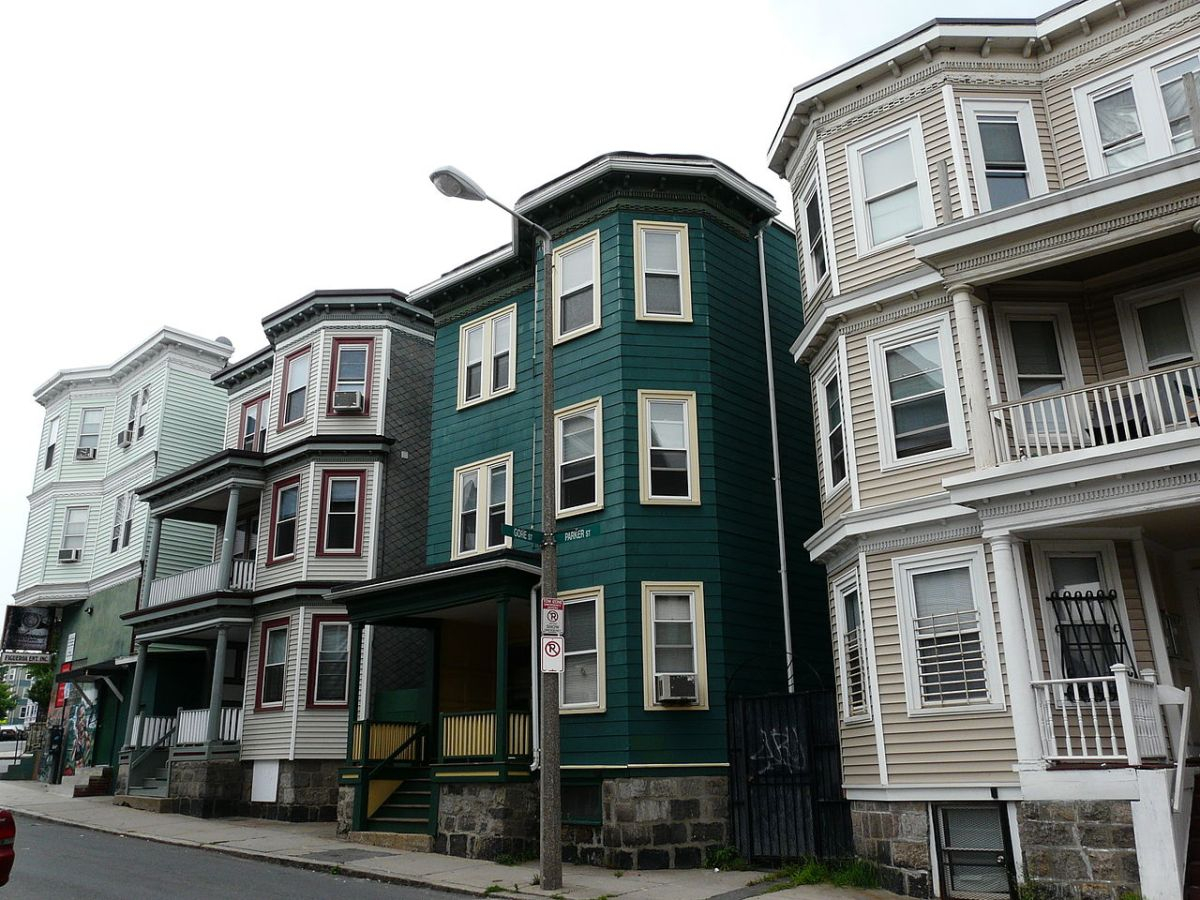 A street with a row of triple deckers A street with a row of triple deckers