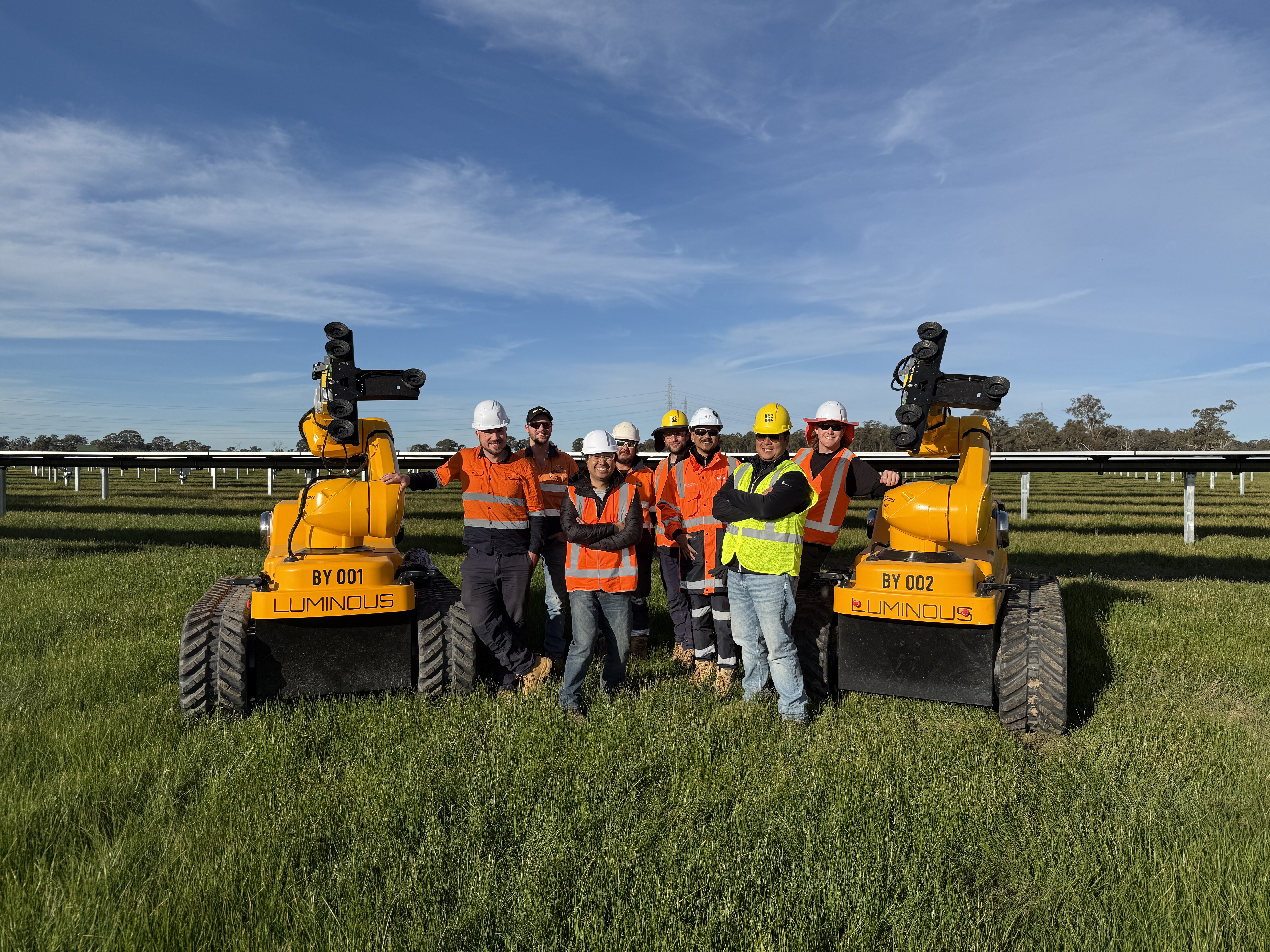 The Luminous team posing next to LUMI on a beautiful day