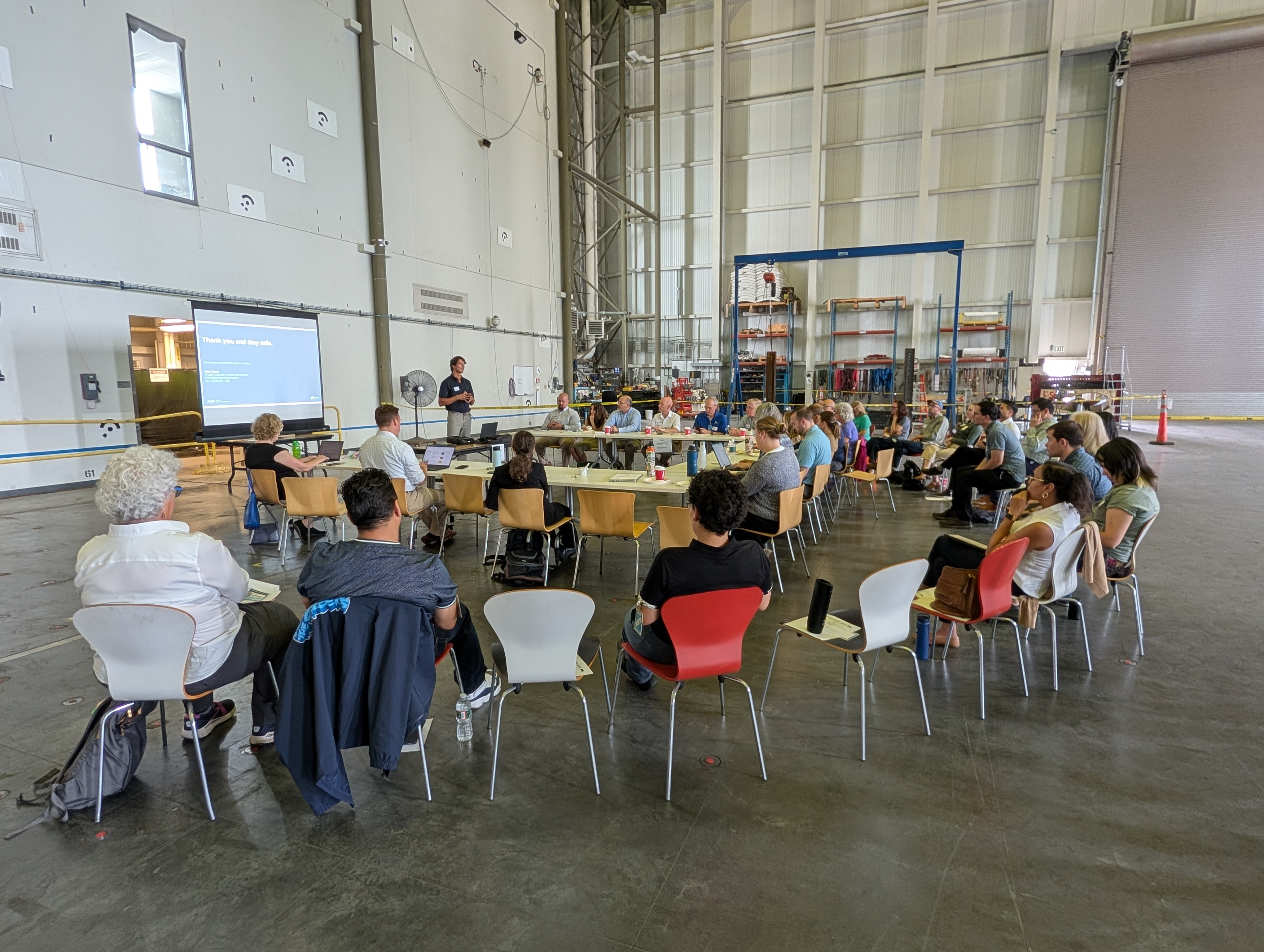 Offshore Wind Workforce Community of Practice members seated for a presentation inside a large wind turbine testing facility.