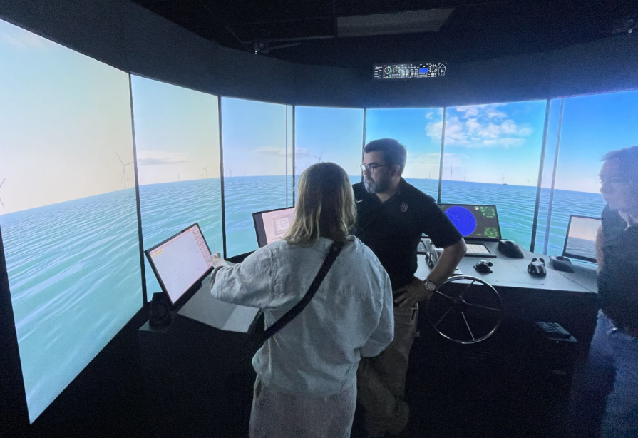 People looking at screens simulating offshore wind functionality.