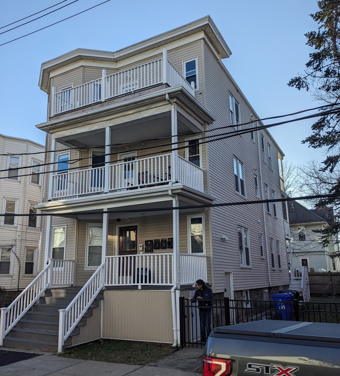 Flat-roofed, three-story wood house in urban setting