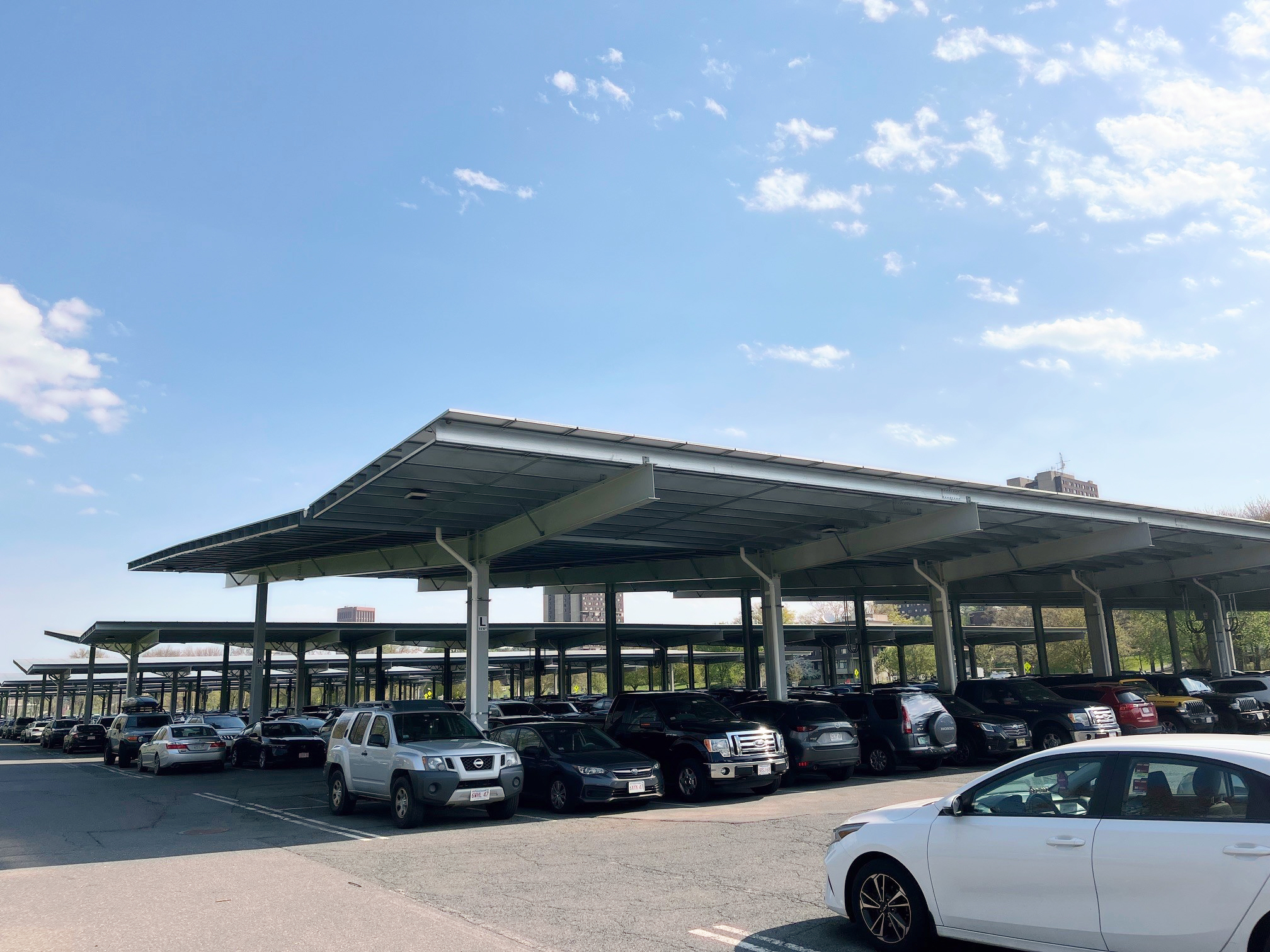 Parking lot with solar panel canopies supporting distributed energy for a microgrid system.
