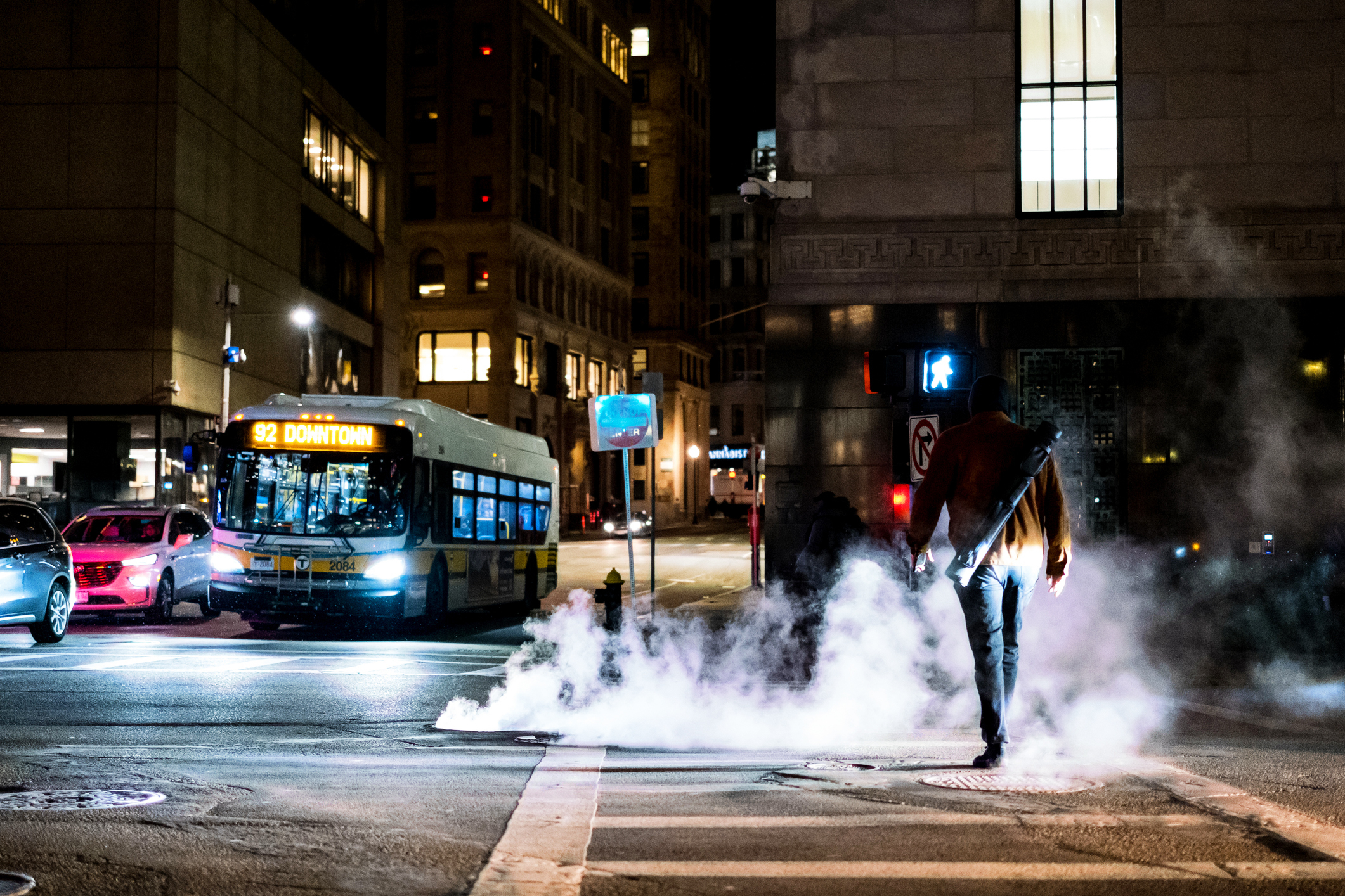 Steam rising from a street in winter due to underground district energy pipes in Boston.